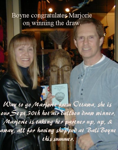 Marjorie accepting her hot air balloon ticket from Boyne